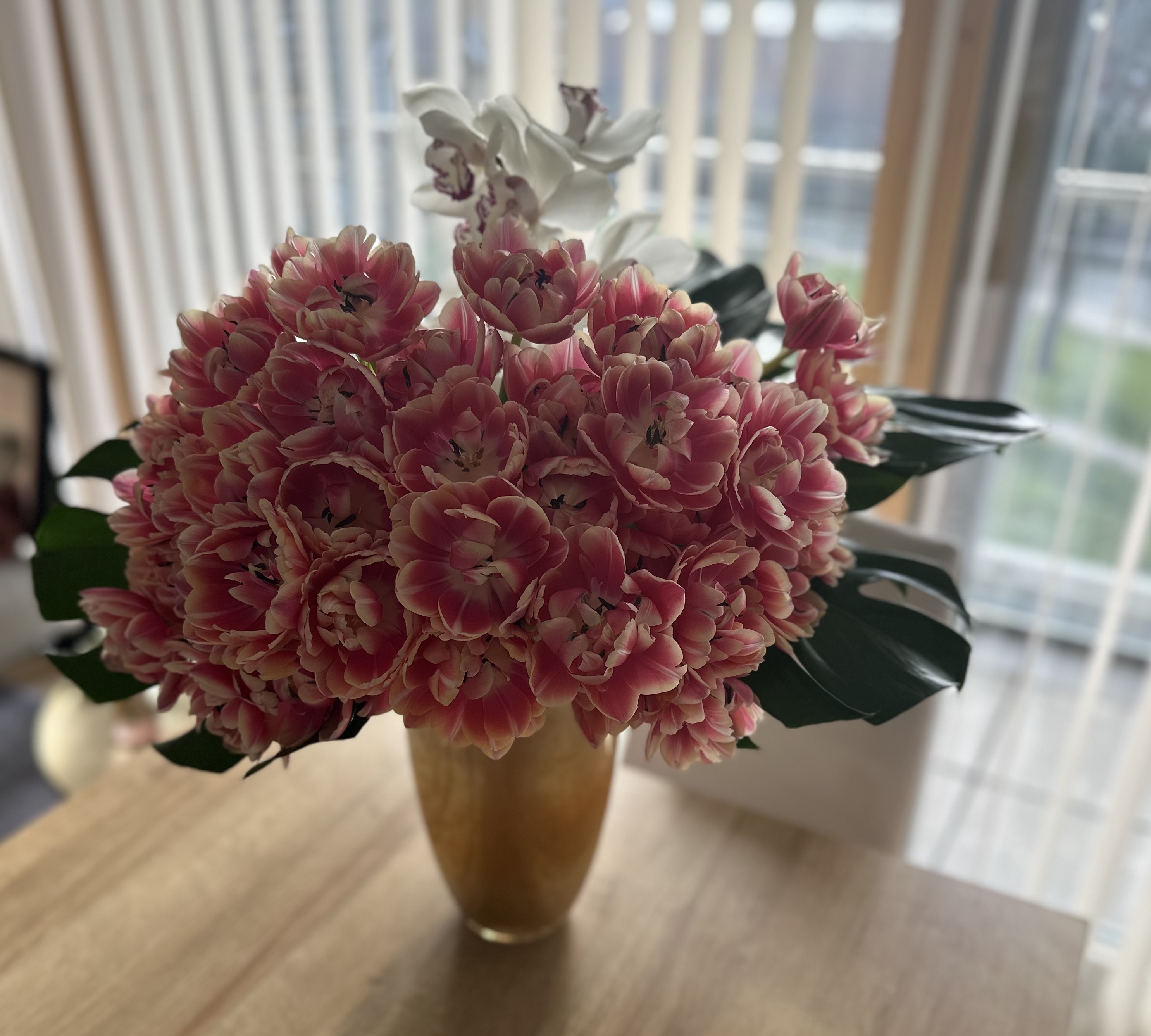 Table arrangement with pink tulips and white orchids